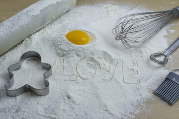 The process of baking cookies at home, closeup on cookie cutter on dough and rolling pin