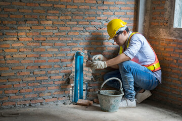 Froman creates red bricks, plaster walls, repairs houses, inspects drains, and bathrooms in houses under construction at Real Estate.