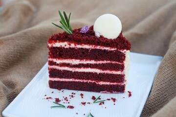 Red velvet cake on white dish.