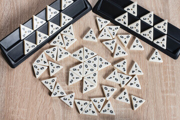 Modern board game trimino laid out on the table for the whole family to play, such a game develops intelligence, speed of thought, helps all family members have fun and spend time together