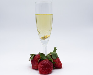 Glasses of champagne with red strawberries and green stem on white background. Valentine's Day. Fresh fruit. Healthy food