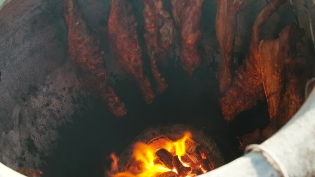 BBQ in big terracotta pot , famouse food selling in local market and restaurant in Thailand