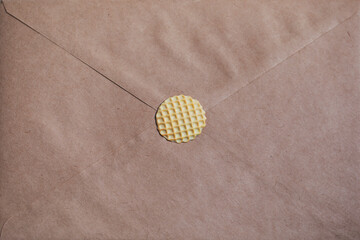 Kraft paper envelope. Handmade miniature polymer clay wafer.