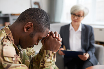African soldier has a depression while visiting his psychologist at office
