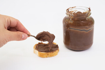 Chocolate peanut butter in a spoon on white.
