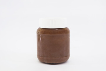 Glass jar with tasty chocolate cream isolated on white