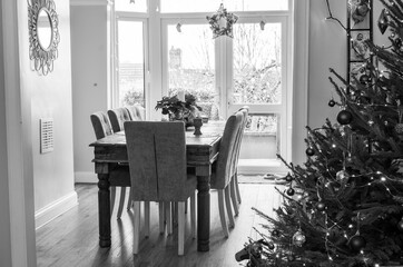 A christmas tree and dining table in black and white