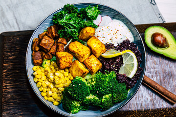 Vegan food with grilled tofu and  buddha bowl top view.