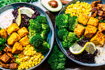 Vegan food with grilled tofu and  buddha bowl top view.