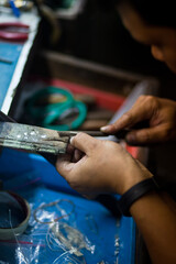 Fototapeta premium Working desk for craft jewelery making with professional tools. Silver production. Master's hands