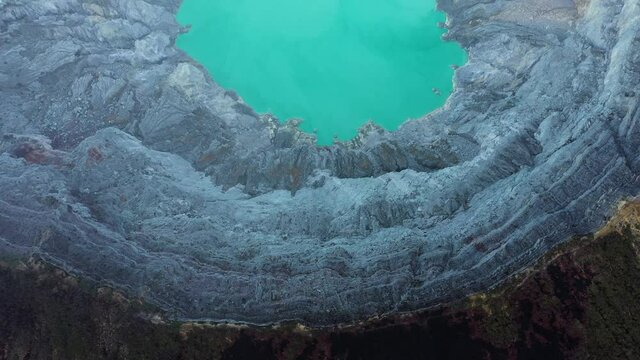 View from above, stunning aerial view of the Ijen volcano with the turquoise-coloured acidic crater lake. The Ijen volcano complex is a group of composite volcanoes located in East Java, Indonesia.