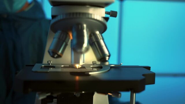 Using microscope in laboratory. Slow motion