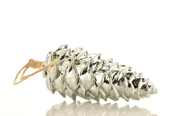 One glass Christmas toy in the shape of a pine cone, close-up, isolated on white.