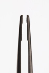 macro photo of dental needle holder on white background