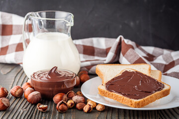 toasts with chocolate butter on a dark wooden rustic background