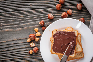 toasts with chocolate butter on a dark wooden rustic background