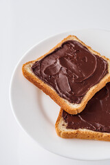 toasts with chocolate butter on a white acrylic background