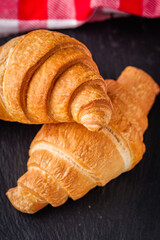 delicious fresh croissant on a white wooden rustic background
