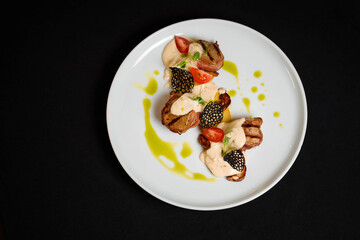 Veal medallion on a white plate on a served table