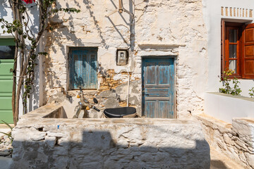 Fototapeta na wymiar View of the facade of a dilapidated building in Chora. Folegandros Island, Greece.