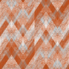 Seamless textured gray, orange zigzag pattern.