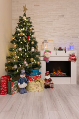 Decorated Christmas tree, gifts, Santa Claus, fireplace. Home atmosphere. New Year, Christmas. Selective focusing.