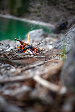 Safety precautions: Campfire near stone in a forest in order to avoid forest fire. Beautiful bonfire near the lake in the mountains