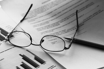 Business legal document concept : Pen and glasses on a agreement form