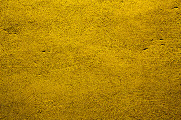 Yellow colored abstract wall background with textures of different shades of gold or yellow