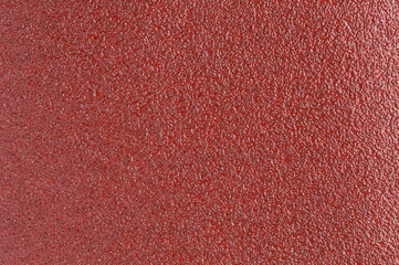 Shiny red sand paper texture background with glitters and sparkles
