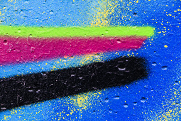 Bright streaks of paint on a blue wall. Empty abstract background.
