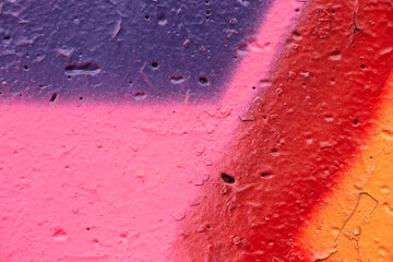 Violet-pink abstract paint streaks on the concrete wall. Empty grunge background.