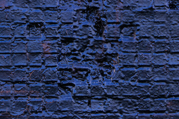 Dark blue brick wall with cracked paint. Empty template and mockup. Grunge and obsolete background.	