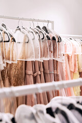 Various dresses in different colors on hangers in a rental service