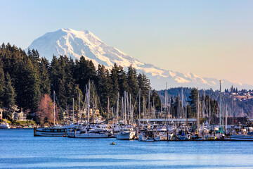 Marina in Gig Harbor Washington with sail and fishing boats, mt rainier in the background
