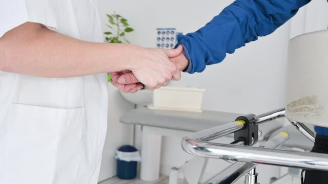 Close up of Physiotherapist assisting a patient with Amyotrophic Lateral Sclerosis. High quality 4k footage.