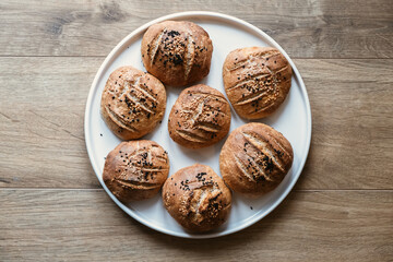 Homemade breads on a white plate. Breads made with organic whole wheat flour. Top view bread on the white plate
