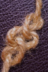 Knot from the jute twine on a dark background
