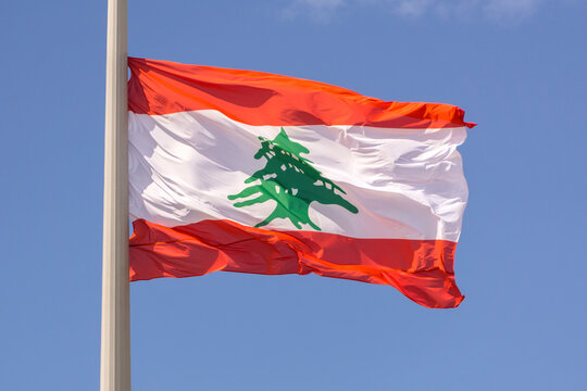 Flag of the Lebanese Republic, a state in the Middle East, on a blue background