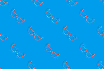 Background on the theme of glasses. Red glasses seamless pattern on a blue background.
