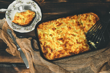 Cottage cheese casserole on a baking sheet. Homemade pie. Kitchen mittens. Dessert. Serving the dish. Foodphoto