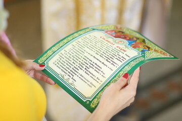 the girl's hands are holding the scripture "Creed". orthodoxy