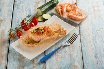 salmon and shrimp wrapped with tomatoes and courgettes