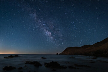 Night landscape with Milky Way on the coast of the Escullos. Natural Park of Cabo de Gata. Spain.