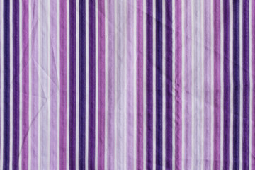The texture of the fabric in purple vertical stripes.