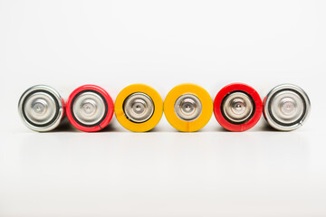 Spent batteries stacked in a row isolated on a white background.