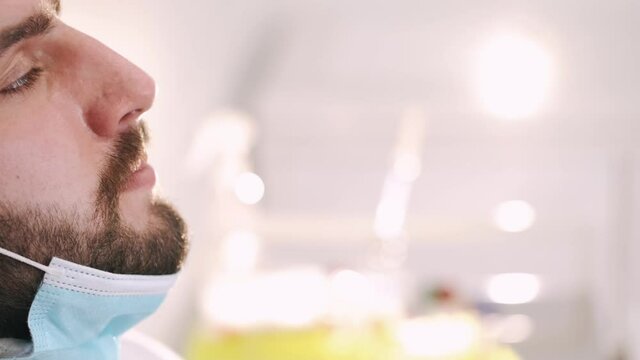 Nasal culture sampling.Female medical worker taking a swab for coronavirus sample plr test from potentially infected man with surgical face masks.