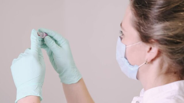 Blood testing, plr test, coronavirus concept. The nurse is looking at blood sample at the doctor office.