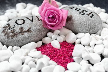 Valentine's Day. Stones with text and pink rose. Pattern of stones in the shape of a heart. Love, close-up, postcard.