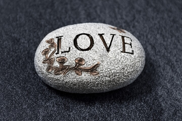 Obraz na płótnie Canvas Stone with text on a brawn background. Close-up. Valentines day.